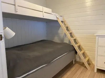 a bunk bed with a ladder in a room at Rosendal Hyttetun in Rosendal