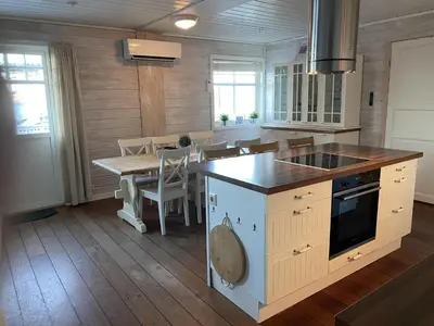 a kitchen with a table and a stove top oven at Rosendal Hyttetun in Rosendal
