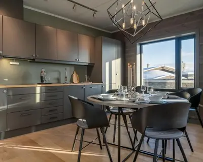 a kitchen with a table and chairs in a kitchen at Riddertunet apartment 104 - in the center of Beitostølen in Beitostøl