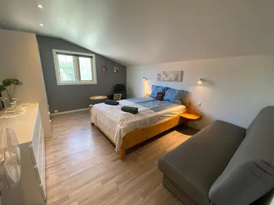 a bedroom with a bed and a couch at Leilighet Sølendet, i Brekken ved Røros in Røros