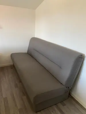 a bed sitting in a corner of a room at Leilighet Sølendet, i Brekken ved Røros in Røros