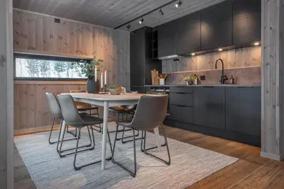 a kitchen with a white table and chairs at Exclusive Suite in the Sunnmøre Alps, Near Geiranger & Hjørundfjord in Stranda