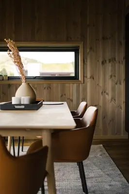a dining room with a table and chairs and a window at Exclusive Suite in the Sunnmøre Alps, Near Geiranger & Hjørundfjord in Stranda