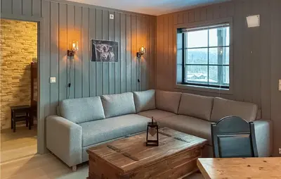 a living room with a couch and a coffee table at Beautiful Apartment In Noresund in Noresund