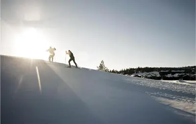 two people are skiing down a snow covered slope at Beautiful Apartment In Noresund in Noresund