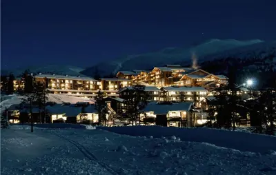 a large building in the snow at night at Beautiful Apartment In Noresund in Noresund