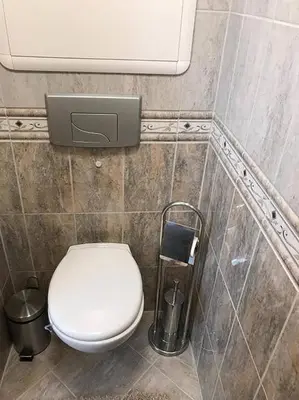 a bathroom with a toilet and a trash can at Apartment in Åsane in Bergen