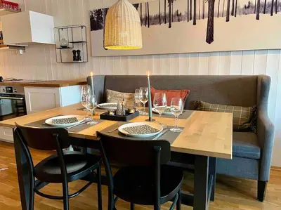 a table and chairs with wine glasses on it at Skarsnuten Panorama 46 in Hemsedal