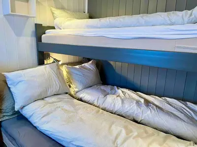 a couple of bunk beds with pillows on a couch at Skarsnuten Panorama 46 in Hemsedal