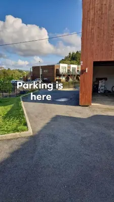a building with a sign that reads parking is here at Near Bergen City, Apartment 7 min from the airport, free parking in Bergen