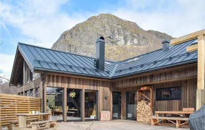 a building with a mountain in the background at 5 Bedroom Nice Home In Hemsedal in Hemsedal