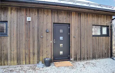 a wooden building with a black door and two windows at 5 Bedroom Nice Home In Hemsedal in Hemsedal
