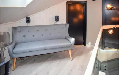a gray couch in a room with speakers on the wall at 5 Bedroom Nice Home In Hemsedal in Hemsedal