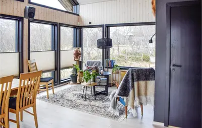 a room with windows and a table and chairs at 5 Bedroom Nice Home In Hemsedal in Hemsedal