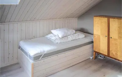 a bed with white sheets and pillows in a room at 5 Bedroom Nice Home In Hemsedal in Hemsedal