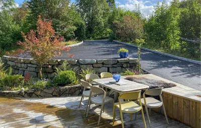 a wooden table and chairs on a patio at Gorgeous Home In Skjold With Kitchen in Skjold