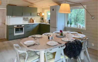 a kitchen with a wooden table with chairs and a dining room at Gorgeous Home In Skjold With Kitchen in Skjold