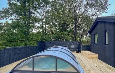 a house with a glass roof on a wooden deck at Gorgeous Home In Skjold With Kitchen in Skjold