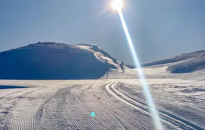 a sun shining on a snow covered mountain with a ski slope at Cozy Apartment In Gol With Wifi in Gol