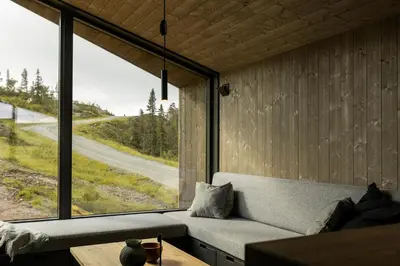 a living room with a couch and a large window at Moderne hytte på Norefjell in Noresund