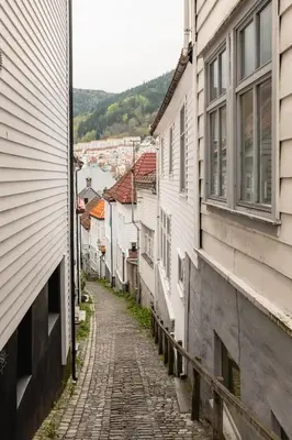 an empty street in a town with buildings at Dinbnb Apartments I Mid-City Luxury with Mini Balcony and Smart TV & Sound System in Bergen