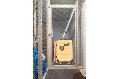 a suitcase is standing in a gate at Dinbnb Apartments I Mid-City Luxury with Mini Balcony and Smart TV & Sound System in Bergen