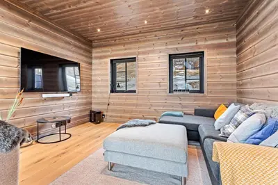 a living room with a couch and a table at Rindabakkane Lodge in Sogndal