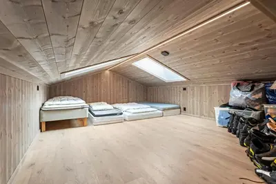 a room with two beds and a skylight at Rindabakkane Lodge in Sogndal
