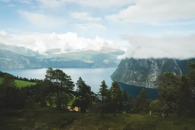 a view of a mountain with a blue lake at Luxury Nordic Suite with Private Sauna and Panoramic Mountain Views in Stranda