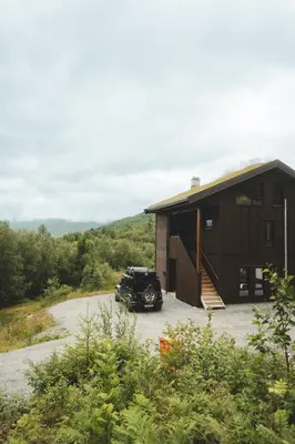 a car parked in front of a building at Luxury Nordic Suite with Private Sauna and Panoramic Mountain Views in Stranda
