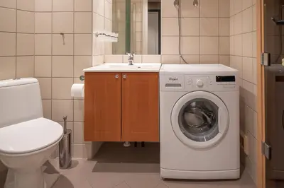 a bathroom with a washing machine and a sink at Høyfjellsgrend 961, 29 B in Trysil