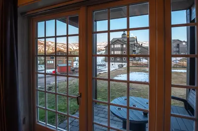 an open window with a view of a city seen through it at Høyfjellsgrend 961, 29 B in Trysil
