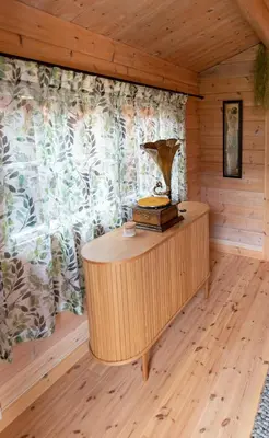 a room with a wooden floor and a wooden desk at Cabin near the lake in Årset