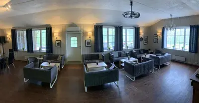 a waiting room with couches and tables and windows at Kårdal Fjellstove in Mjølfjell