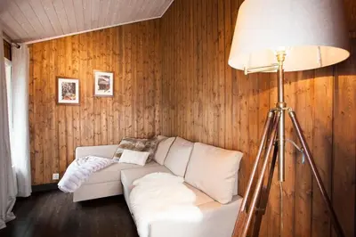 a living room with a white couch and a lamp at Luxury cabin in the mountains with all facileties in Sønstebø