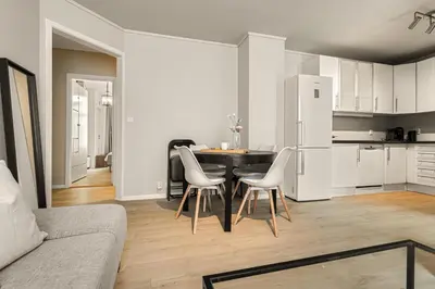 a kitchen with a table and chairs in a room at Family Friendly - Modern - City Central in Bergen