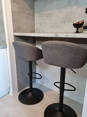 two chairs sitting next to a counter in a kitchen at Apartment near center / free P in Ålesund