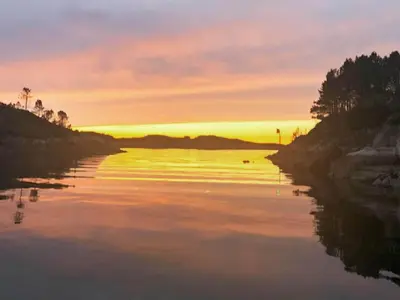 a river with a sunset in the background at 8 person holiday home in averøy-By Traum in Averoy