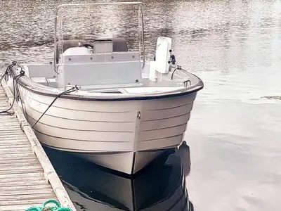 a boat parked next to a dock in the water at 8 person holiday home in averøy-By Traum in Averoy
