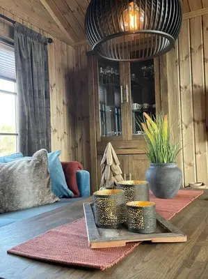 a living room with a table with bowls of food at Hjemmekoselig hytte på Rauland in Rauland