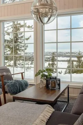 a living room with a table and a large window at Holiday home in beautiful Sjusjøen, near Lillehammer in Ringsaker