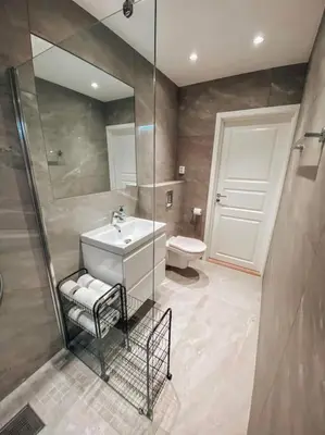 a bathroom with a sink and a shower and a toilet at Trolltunga Sleep in Tveit