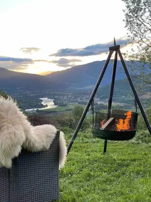 a swing with a teddy bear sitting in a chair at Traditional barn -Stabbur - wifi og sauna in Baukål