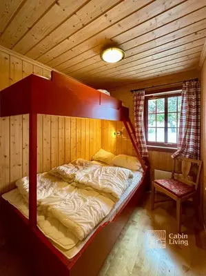 a bedroom with a bunk bed in a cabin at Large cabin with Sjusjøens best view, sauna and ski in out in Ringsaker
