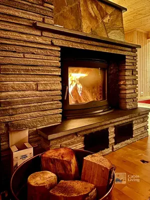 a living room with a fireplace and two stools at Large cabin with Sjusjøens best view, sauna and ski in out in Ringsaker