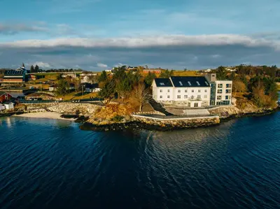 an aerial view of a building on an island in the water at Biologen Herdla in Askøy
