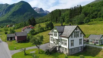 an aerial view of a house in a valley with mountains at Monshaugen Home - Privat Retreat in Sykkylven
