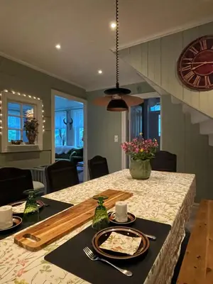 a dining room table with plates and utensils on it at Monshaugen Home - Privat Retreat in Sykkylven