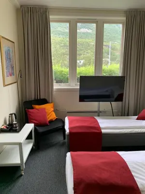 a hotel room with two beds and a window at Sitla Hotel & Apartments in Øvre Årdal