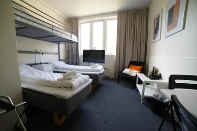 a hotel room with two beds and a tv at Sitla Hotel & Apartments in Øvre Årdal
